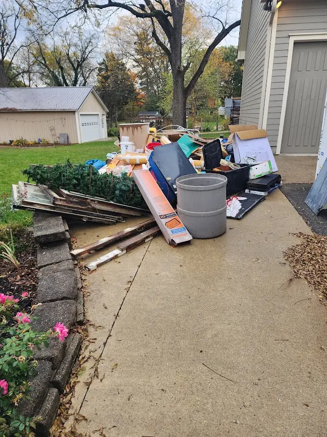 Dumpster being loaded with debris for 3 Yard Dumpster Rental in Port Jefferson